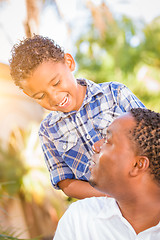 Image showing Mixed Race Son and African American Father Playing Outdoors Toge