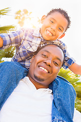 Image showing Mixed Race Son and African American Father Playing Piggyback Out