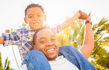 Image showing Mixed Race Son and African American Father Playing Piggyback Out