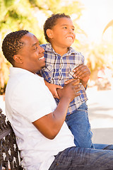 Image showing Mixed Race Son and African American Father Playing Outdoors Toge