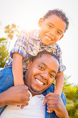 Image showing Mixed Race Son and African American Father Playing Piggyback Out