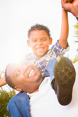 Image showing Mixed Race Son and African American Father Playing Piggyback Out