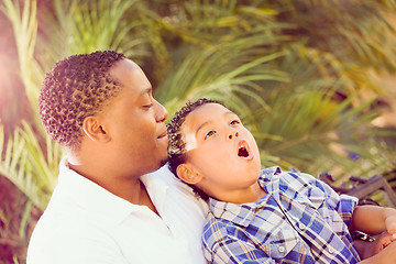 Image showing Mixed Race Son and African American Father Playing Outdoors Toge