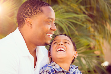 Image showing Mixed Race Son and African American Father Playing Outdoors Toge