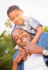 Image showing Mixed Race Son and African American Father Playing Piggyback Out