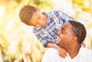 Image showing Mixed Race Son and African American Father Playing Outdoors Toge