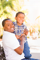 Image showing Mixed Race Son and African American Father Playing Outdoors Toge