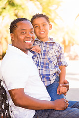 Image showing Mixed Race Son and African American Father Playing Outdoors Toge