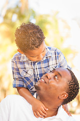 Image showing Mixed Race Son and African American Father Playing Outdoors Toge