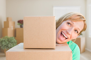 Image showing Happy Young Adult Woman Holding Moving Boxes In Empty Room In A 