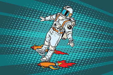 Image showing The astronaut is flying on a space rocket skateboard
