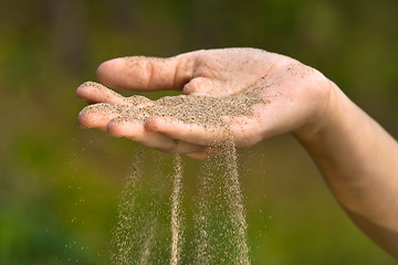 Image showing sand running through hand like time running out