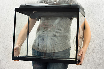 Image showing woman holding empty aquarium to restart it