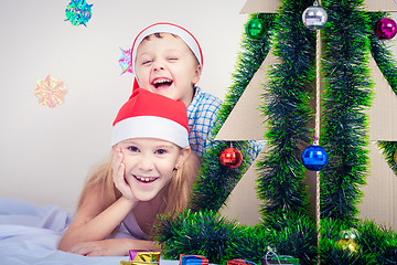 Image showing Happy little smiling boy and girl with christmas hat.