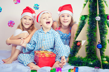 Image showing Happy little smiling boy and girls with christmas hat.