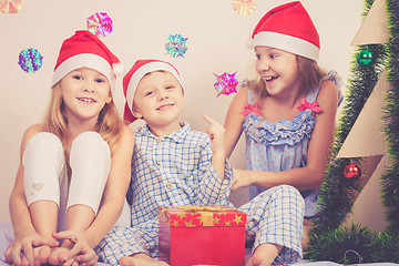 Image showing Happy little smiling boy and girls with christmas hat.