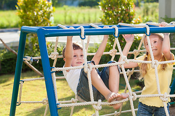 Image showing happy brother and sister playing on the playground 