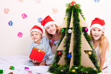 Image showing Happy little smiling boy and girls with christmas hat.