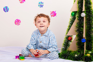 Image showing Happy little smiling boy with christmas gift box.