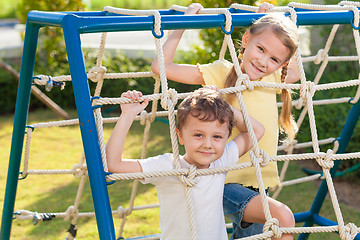 Image showing happy brother and sister playing on the playground