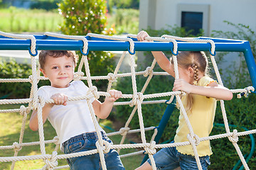 Image showing happy brother and sister playing on the playground