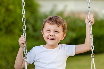 Image showing happy little boy playing on playing on the playground 