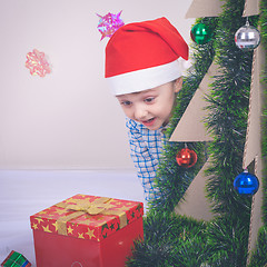 Image showing Happy little smiling boy with christmas gift box.