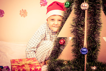 Image showing Happy little smiling boy with christmas gift box.