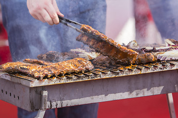 Image showing Chef bbq grilled pork ribs on smoke