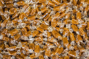 Image showing A lot of  Caramel candies Wrapped in cellophane