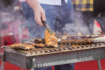 Image showing Chef bbq grilled pork ribs on smoke