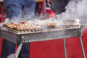 Image showing Chef bbq grilled pork ribs on smoke