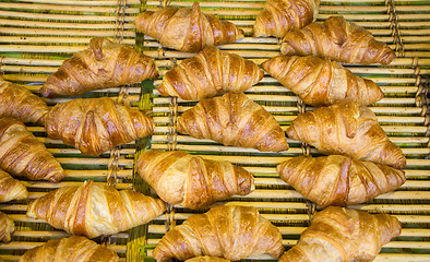 Image showing Freshly baked French croissants in street bakery store 