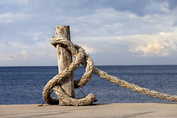 Image showing Rope on seafront and cloudy sky in sun autumn day