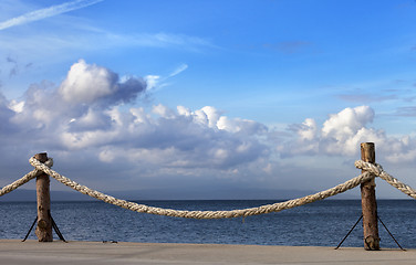 Image showing Seafront and sky with sunlight clouds in autumn evening