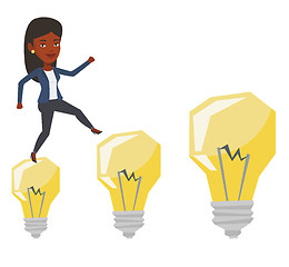 Image showing Business woman jumping on idea bulbs.