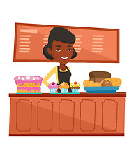 Image showing Worker standing behind the counter at the bakery.