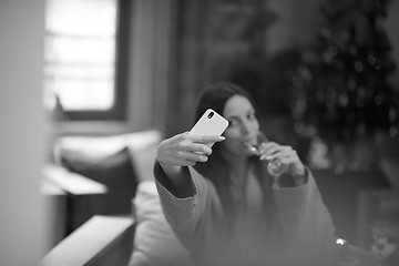 Image showing woman drinking doing selfy at spa