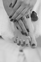 Image showing female feet and hands at spa salon