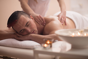 Image showing young man having a back massage