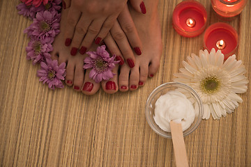 Image showing female feet and hands at spa salon