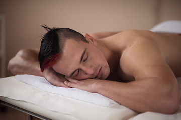 Image showing handsome man resting in a spa massage center