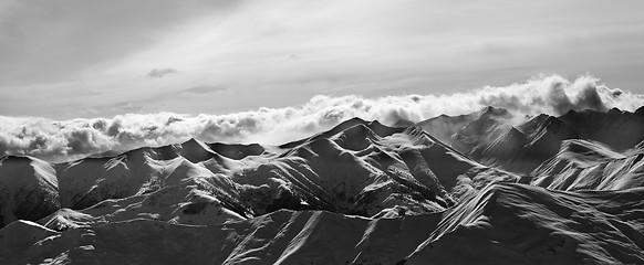 Image showing Black and white panorama of evening snow mountains at winter