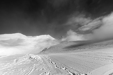 Image showing Black and white view on ski slope with footprints