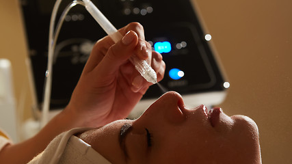 Image showing Face Beauty Treatment. Closeup Of Beautiful Woman Getting Facial Gas-liquid Oxygen Water Epidermal Peeling Using Professional Equipment At Cosmetology Center. Skin Care Concept.