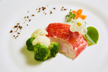 Image showing The red snapper with vegetable. Shallow dof.