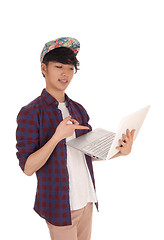Image showing Asian teenager pointing at his laptop.