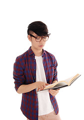 Image showing Young Asian man reading book.