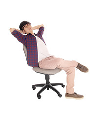 Image showing Asian teenager relaxing on chair.