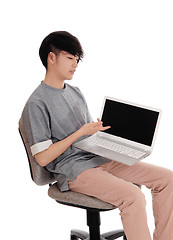 Image showing Asian teenager pointing at his laptop.